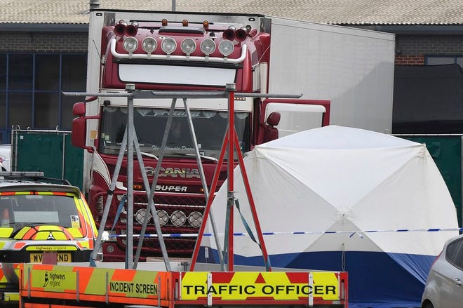 View of a truck, seen in rear, that was found to contain a large number of dead bodies, in Thurrock, South England, early Wednesday Oct. 23, 2019. Police in southeastern England said that 39 people were found dead Wednesday inside the truck container believed to have come from Bulgaria.