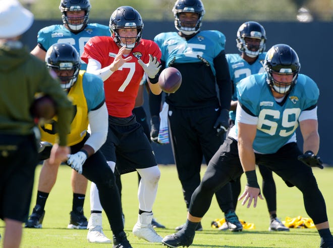 Jaguars quarterback Nick Foles takes his first snap in practice Wednesday since being injured in the season-opening game. [Bob Self/Florida Times-Union]