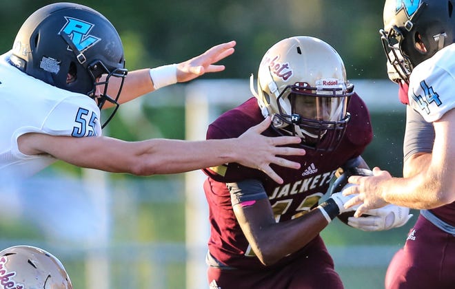 St. Augustine running back Anfernee Wilson (13) evades the outstretched arms of Ponte Vedra's Will Frank during the first half of a Sept. 7, 2018 football game. Friday, the Yellow Jackets (5-3, 2-0) travel to Ponte Vedra (6-1, 2-0) with the District 3-6A title on the line. [Gary Lloyd McCullough/Correspondent]