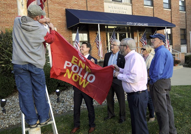 City of Ashland Maintenance Department employee David Rhoades is assisted by Mayor Matt Miller and Ashland Rotary member Lee Peters in raising the Rotary’s End Polio Now flag to mark World Polio Day as Rotary members Ted Daniels, Maryanne Wise and Tom Roepke look on Thursday outside of the Municipal Building. The eradication of polio, which once crippled millions, has been a major project of Rotary International and the local club for more than 30 years. The cases of polio have been reduced by 99.9 percent, but is rising slightly with more than 200 cases reported in 2019 in three countries — Pakistan, Afghanistan and Nigeria.