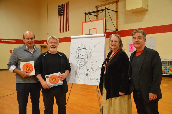 From left, orthodontist Dr. Joseph Yamin, author and illustrator Peter Reynolds, retired Fitchburg State University Professor Helen Obermeyer Simmons and Reynolds’ twin brother Paul surround a drawing Reynolds made specially for his visit to Johnny Appleseed Elementary School. [DAVID DORE PHOTO]