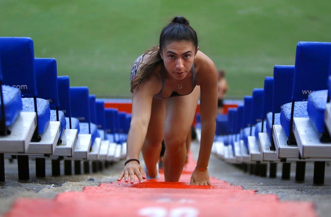 Danielle Gertner, who started the Gator Grind Boot Camp, does a bear crawl up the stairs at Ben Hill Griffin Stadium in October 2018. She and others will have until 8 p.m. daily to use the stadium for exercise, an hour later than the 7 p.m. cerfew UF imposed in June. [Brad McClenny/Staff photographer]