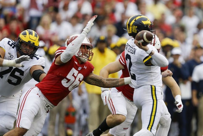 Wisconsin defensive end Rodas Johnson closes in on Michigan quarterback Shea Patterson during the Badgers' 38-0 victory on Oct. 12. The Badgers rank first in the nation in a number of major defensive categories. [Andy Manis/The Associated Press]