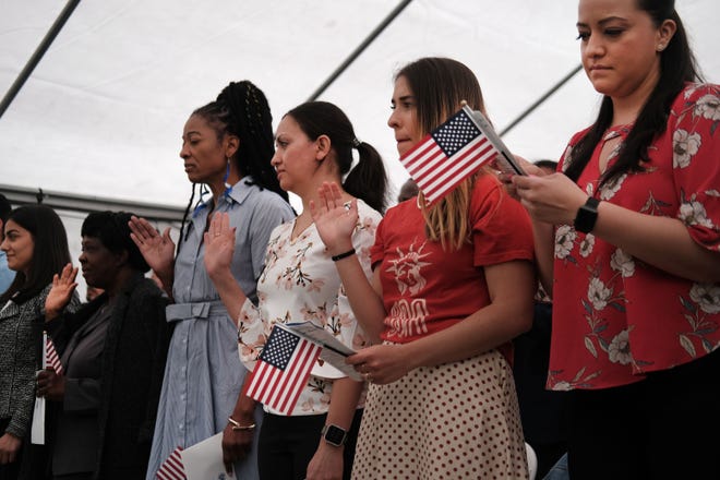 People from a total of 27 nations participate in a Naturalization Ceremony in Brooklyn on June 14, 2019 in New York City. Joined by family and friends, over 30 individuals became American citizens in the morning ceremony at the historic Wyckoff House Museum. (Photo by Spencer Platt/Getty Images/TNS)