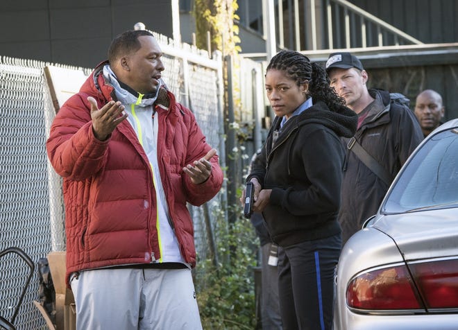 This image released by Sony Pictures shows director Deon Taylor, left, and Naomie Harris on the set of Screen Gems "Black and Blue." After making successful movies independently for 15 years, Hollywood is starting to take notice of Taylor. This year he has two major films in theaters. þÄúThe IntruderþÄù became a solid hit in May, and his police thriller þÄúBlack and BlueþÄù opens nationwide Thursday. (Alan Markfield/Sony Pictures via AP)