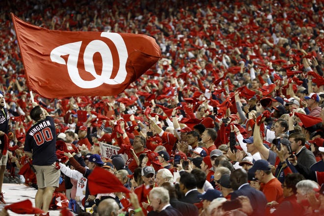 Washington Nationals fans cheer before Game 3 of the baseball World Series against the Houston Astros on Friday in Washington. Game 4 is scheduled for Saturday. [PATRICK SEMANSKY/THE ASSOCIATED PRESS]