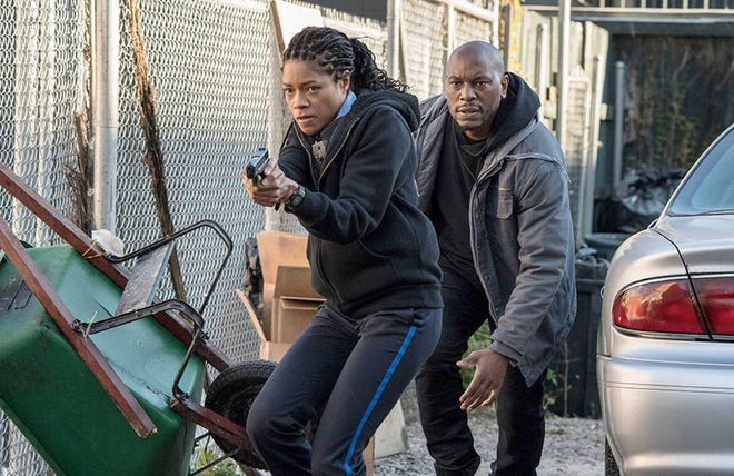 Naomie Harris, left, and Mike Colter star in the action-thriller, "Black and Blue," which is now in theaters. [PHOTO COURTESY OF HIDDEN EMPIRE FILM GROUP/ROYAL VIKING ENTERTAINMENT]