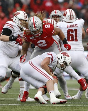 Ohio State defensive end Chase Young (2) sacks Wisconsin quarterback Jack Coan during the second quarter; it was one of Young's four sacks in the game. [Adam Cairns/Dispatch]