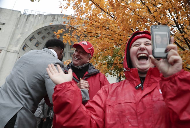 Keith Carpenter, second from left, of Whitehouse, Ohio, greets Ohio State Buckeyes wide receiver K.J. Hill Jr., left, as he walks to Ohio Stadium with his team before a NCAA Division I college football game between the Ohio State Buckeyes and the Wisconsin Badgers on Saturday, October 26, 2019 in Columbus, Ohio. [Joshua A. Bickel/Dispatch]