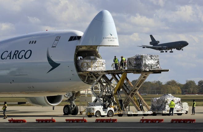 Employees at Rickenbacker International Airport unload a Cathay jet on Tuesday. The airport prides itself on its unloading times and promotes Columbus' location as ideal for reaching hundreds of millions of U.S. and Canadian customers. For those reasons and others, airport executives are confident their cargo buisness will continue growing long-term. [Eric Albrecht/Dispatch]