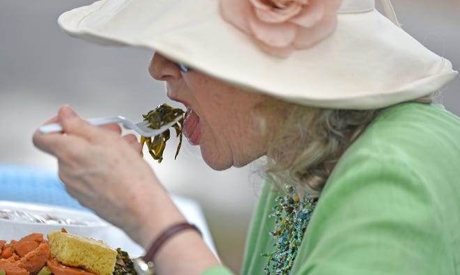 Carol Williamson samples some collard greens at the fourth annual Big Mama's Collard Greens Fest on Saturday at the Robert L. Taylor Community Complex in Newtown. [HERALD-TRIBUNE STAFF PHOTO / THOMAS BENDER]