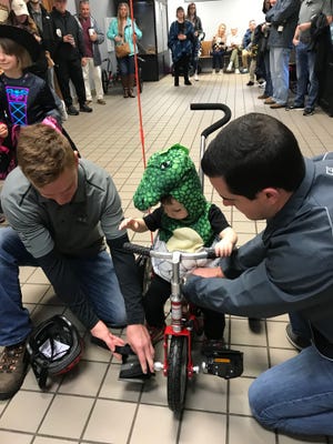 Atlas Kreoger, 2, gets fitted for his new Amtryke. The adaptive tricycles were donated to Kreoger and four other children at Henson Robinson Zoo Saturday morning. [Brenden Moore/The State Journal-Register]