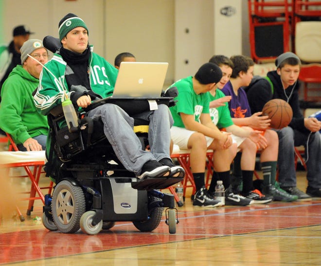 Jonah Shea, shown in 2013, watches a game from the sidelines in the youth basketball association he founded. Shea remains honorary chairman of the association. [Ron Schloerb/Cape Cod Times file]
