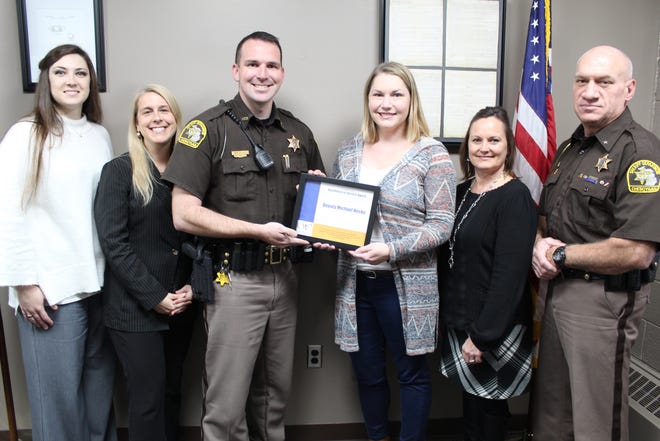 Deputy Michael Hecko of the Cheboygan County Sheriff's Department received the Excellence in Service Award presented by Women's Resource Center of Northern Michigan to recognize his work in promoting domestic violence victim safety and offender accountability. Also pictured are (from left) Amber Libby, Cheboygan County Assistant Prosecuting Attorney; Melissa Goodrich, Cheboygan County Prosecuting Attorney; Hecko; Amber Whitmore-Michel, WRCNM counselor/advocate; Celeste Charboneau, Victims' Rights advocate with the Cheboygan County Prosecutor's Office; and Dale Clarmont, Cheboygan County Sheriff. Photo by Kortny Hahn