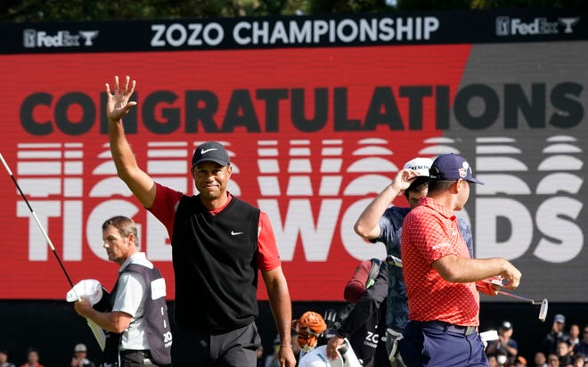 Tiger Woods of the United States celebrates after winning the Zozo Championship PGA Tour in Inzai City, Japan, on Monday. [AP Photo/Lee Jin-man]