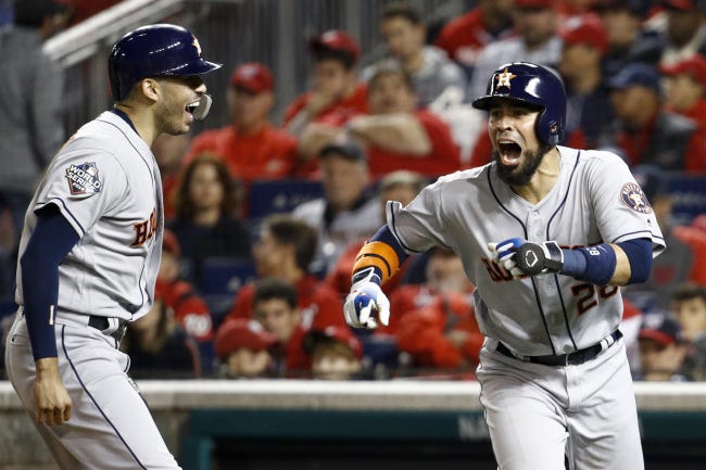 Houston Astros' Robinson Chirinos, right, celebrates his two-run home run with Carlos Correa during the fourth inning of Game 4 of the World Series against the Washington Nationals on Saturday night. The Astros won 8-1 to even the series 2-2. [AP Photo/Patrick Semansky]