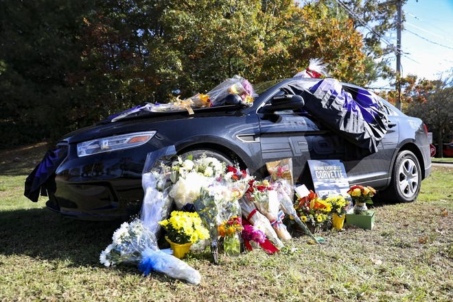 The cruiser in honor of Easton Police Officer Patrick Taylor is covered in bunting and surrounded by flowers as it is parked outside the Easton Police Station on Monday, Oct. 21, 2019. [Enterprise Photo | Alyssa Stone]