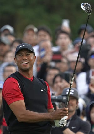 Tiger Woods watches his tee shot on the 8th hole during the final round of the Zozo Championship at Accordia Golf Narashino Country Club in Japan on Sunday. [The Associated Press]