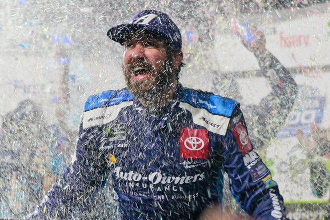 Martin Truex Jr. is doused with water and confetti after winning a NASCAR Cup Series race at Martinsville Speedway on Sunday in Martinsville, Va. [AP Photo/Steve Helber]