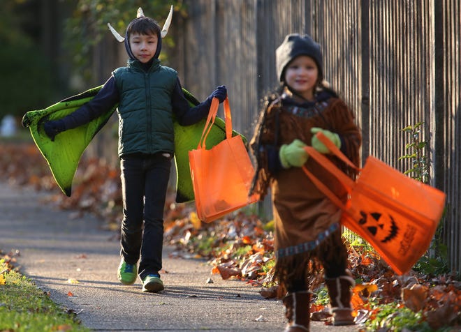 Blending winter jackets and caps with Halloween costumes was a necessity because of frigid conditions in 2014. This year's Halloween is also likely to see cold temperatures. [State Journal-Register file photo]