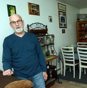 Dennis Ossont, 61, relaxes at his Cedar Glen apartment in Norwichon Tuesday. He said: "My rent here is very favorable. It hasn't gone up in three years." [John Shishmanian/ NorwichBulletin.com]