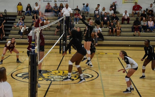 Buchholz senior Kennedy Wade delivers a kill during Tuesday's match against Chiles in Tuesday's Class 6A regional semifinals. (Photos by Larry Savage/Staff)