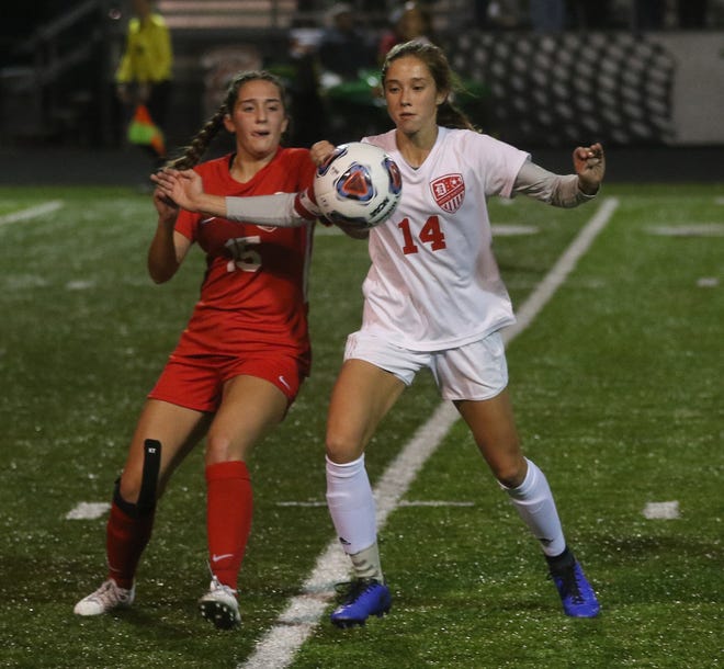 Grace Smith of Dover (right) and Kelsie Mannasmith of Norwayne go for control of the ball in the Division II girls regional soccer semifinal match at Canton South High Tuesday. (TimesReporter.com / JIm Cummings)