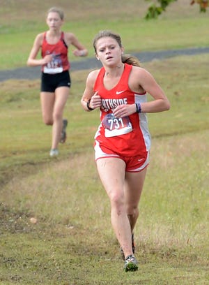 Northside cross country runner Felicity West makes her way through a wet course in Ben Geren Regional Park during the 6A Central Cross Country Meet on Monday. West finish in second place during the meet. [BRIAN D. SANDERFORD/TIMES RECORD]