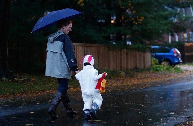 Umbrellas and coats may be appropriate for those trick-or-treating on Thursday. [Dispatch file photo]