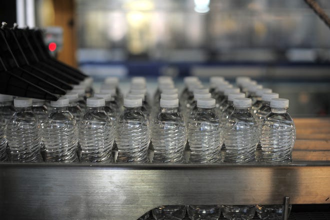 Bottled water is still being provided to students, faculty and staff at Reddick-Collier Elementary School. These bottles were being guided down the production line at the Azure Water bottling plant in Leesburg back in 2014. [Brett Le Blanc / Daily Commercial]