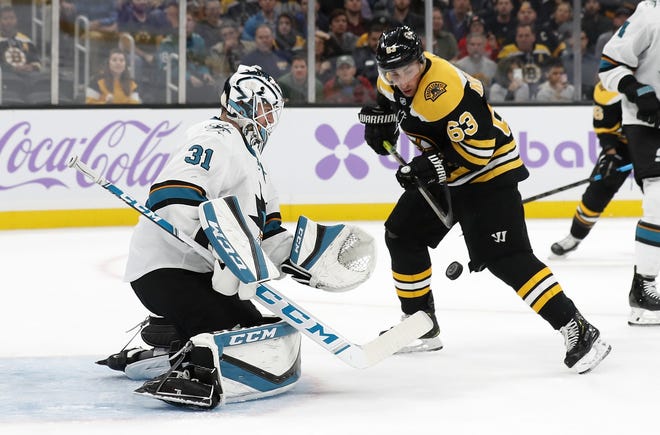 The Bruins' Brad Marchand looks for a rebound off a save by Sharks goaltender Martin Jones in the first period of Tuesday night's game. [AP / Winslow Townson]