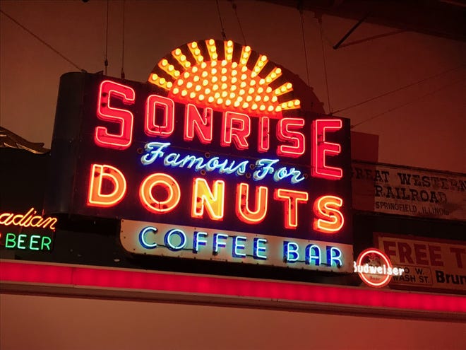 The Sonrise Donut sign, one of Springfield’s iconic Route 66 landmarks, was officially relit during a ceremony held at Ace Sign Company Museum. The city paid $22,000 at auction in 2018 to purchase the sign. [Brenden Moore/The State Journal-Register]