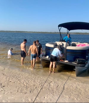 The Watson family anchors a borrowed pontoon boat at Shell Island for a family outing. [CONTRIBUTED PHOTO]