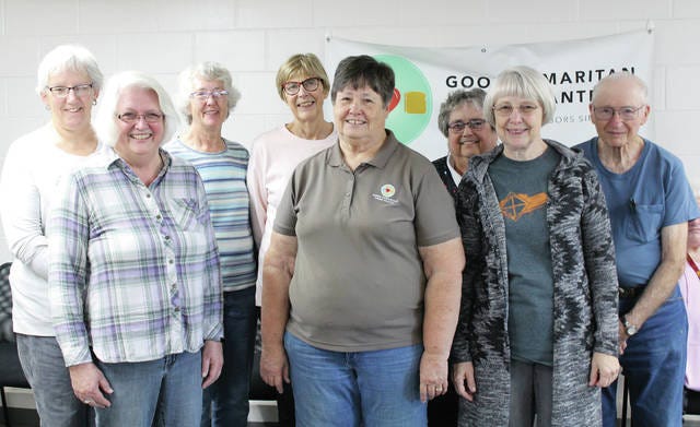 Some of the Good Samaritan Food Pantry volunteers include Jackie Krogh, Ginnie Peters, Roland Joiner, Marlene Schiefelbein, Maureen Rohret, Donna Scharlau, Bonnie Conover and Celia. PHOTO BY TK WEST/DALLAS COUNTY NEWS