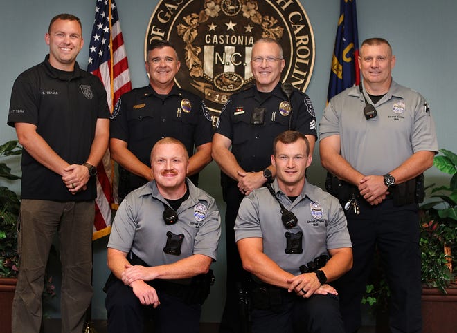Several officers at the Gastonia Police Department will be taking part in No Shave November to raise money for Gaston County Special Olympics. (L-R standing) Detective Eric Seagle, Assistant Chief Travis Brittain, Sgt. Scott Norton and Sgt. Thomas Doby. (L-R kneeling) patrol Officer Sam Barksdale and Patrol Officer Josh Wood. [Mike Hensdill/The Gaston Gazette]