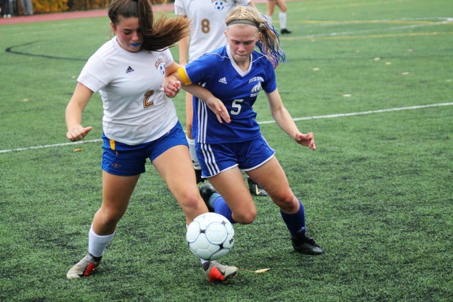 Oyster River's Nathalie Pare (5) and Kearsarge's Thea Spanos battle for a 50/50 ball during Thursday's Division II playoff match in Durham. [Al Pike/Seacoastonline]