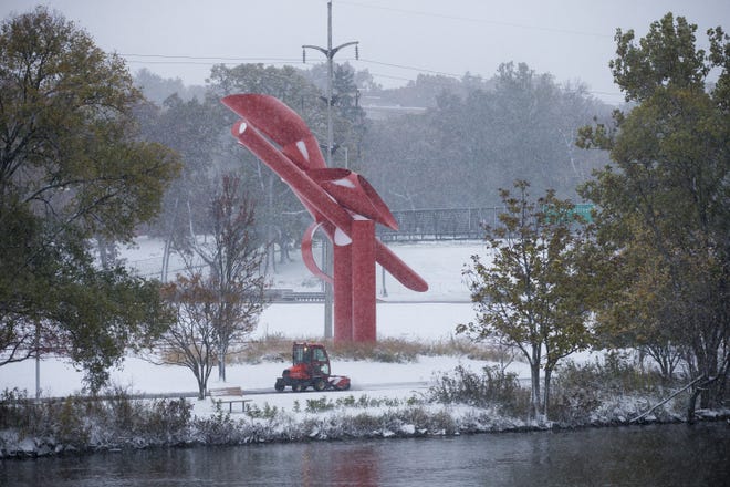 A plow clears the path Thursday, Oct. 31, 2019, along the Rock River Recreation Bike Path at the Symbol in Rockford. [SCOTT P. YATES/RRSTAR.COM STAFF]