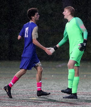 Norwell goalie Alec Pettit celebrates his clean sheet with Jacob Delphin after their 1-0 win over Marshfield on Wednesday, Oct. 9, 2019. [Wicked Local Staff Photo/ Robin Chan]