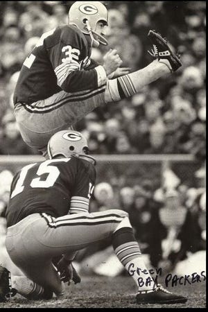 Booth Lusteg kicking field goal for the Packers.