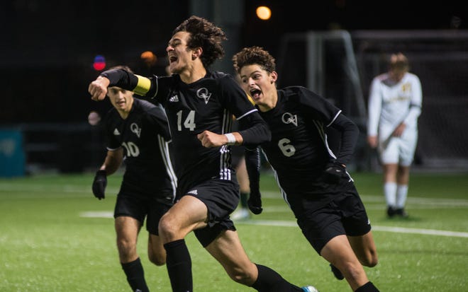 Dom Reiter (14) celebrates his game-winning goal as he’s chased by teammates Brody Jones (6) and Frank Fernandez (10) after Quaker Valley won the WPIAL Class 2A championship Friday night [Andrew Chiappazzi/BCT Staff]