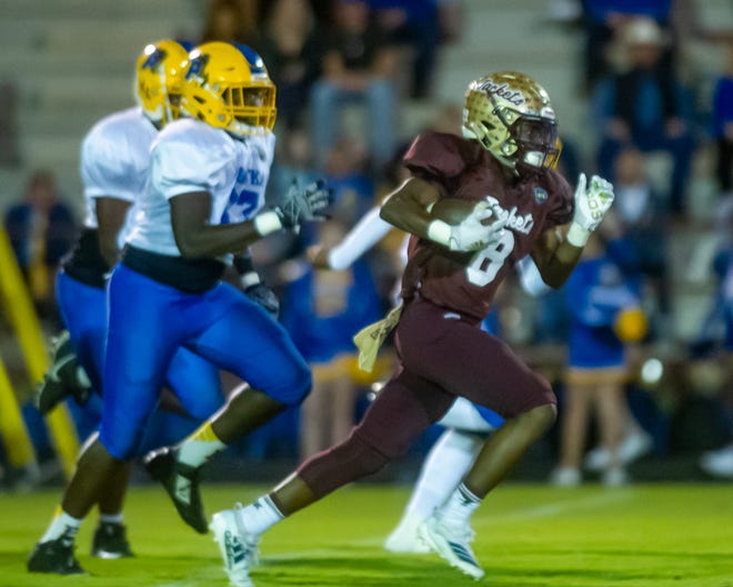 St. Augustine’s Justus Johnson (8) takes off downfield for a large gain in the first half of their 100th meeting with Palatka Friday night. [Fran Ruchalski/For the St. Augustine Record]