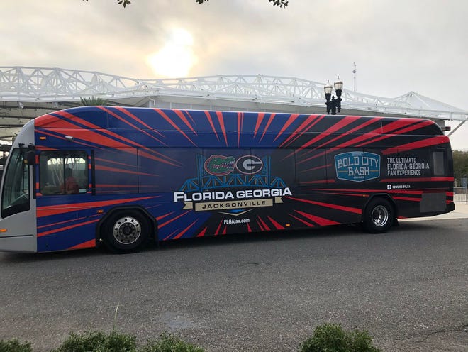 JTA wrapped some of its buses for Florida-Georgia use in these game-day colors of orange and blue for UF and red and black for UGA. [JTA]