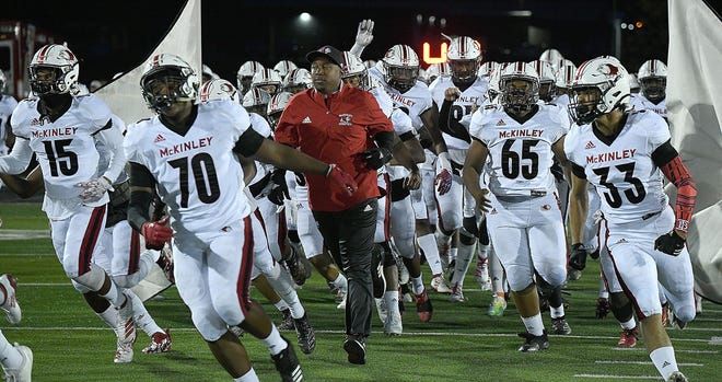 McKinley coach Marcus Wattley runs onto the field before last week's game against Perry. (CantonRep.com / Ray Stewart)