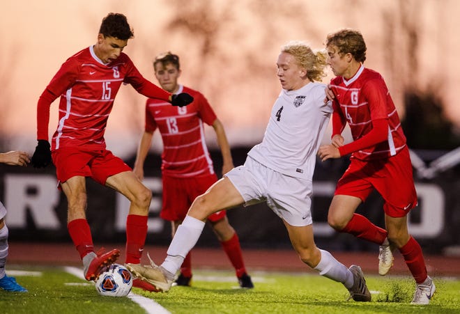 Glenwood's Garrett Kroeschel and Riley Hochstein defend as Troy Triad's Jake Ellis pushes upfield during the Class 2A Bethalto Civic Memorial Sectional championship at Collinsville High School on Friday, Nov. 1. [Ted Schurter/The State Journal-Register]