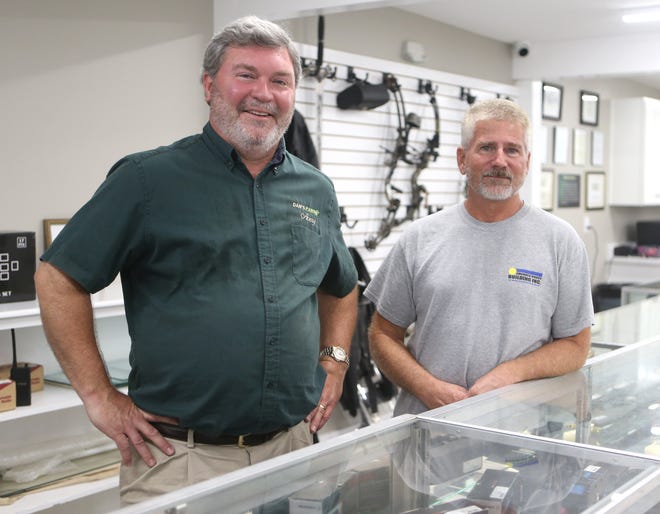 Dan’s Pawn owner Avery Adcock stands with Emerald Coast Building Inc.'s Mike Castleman on Oct. 30, 2019 at Dan's Pawn. [PATTI BLAKE/THE NEWS HERALD]