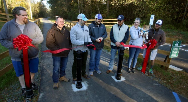 The ribbon is cut during the River Link Greenway grand opening held early Saturday morning, November 2, 2019, near Goat Island Park in Cramerton. [Mike Hensdill/The Gaston Gazette]