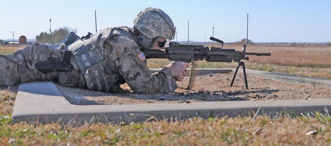 Specialist Travis Warren, of Lawrence, shoots a M240 bravo machine gun at targets during the three-day Kansas Army National Guard Best Warrior Competition at the Kansas Training Center Range Complex outside of Salina on Friday. [AARON ANDERS/SALINA JOURNAL