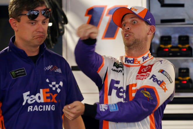 Denny Hamlin, right, talks to crew chief Chris Gabehart after qualifying for the NASCAR Cup Series race at Martinsville Speedway last week. [ASSOCIATED PRESS]
