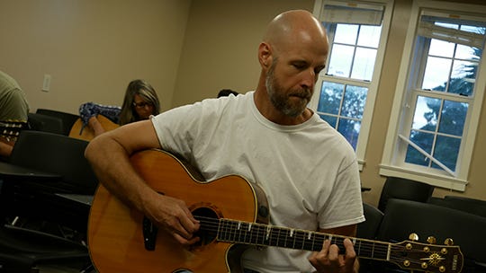 An ACE student practices guitar during a Lifelong Learning class. The program celebrated another anniversary this week. [CONTRIBUTED]