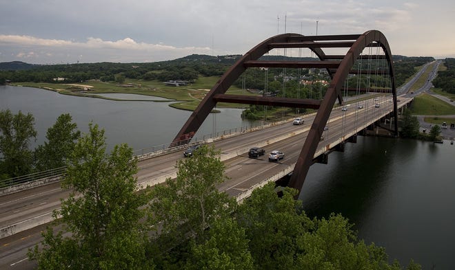 The careful trek up to the overlook of the Pennybacker Bridge is worth the view of the lake and one of Austin's most notable architectural features. (Photo by NICK WAGNER / AMERICAN-STATESMAN)